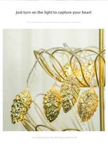 Macro shot of realistic golden pine cone LED string lights with warm yellow glow
