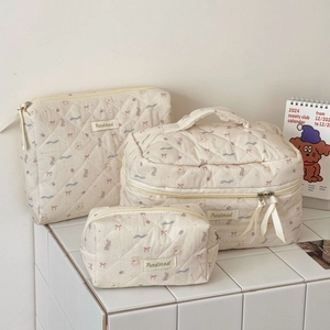 Detailed set of three cream quilted makeup bags with cute bear and floral embroidery
