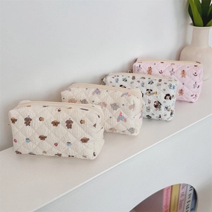 Detailed close-up of quilted cotton pencil cases with cute cartoon animal patterns