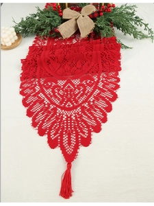 Close-up of red lace table runner with intricate hollow floral patterns and tassels