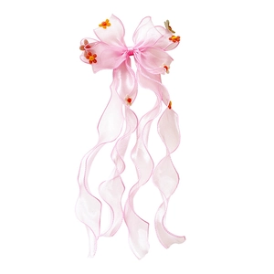 Sweet pink bow hair clip for girls featuring long ribbons and small floral decorations