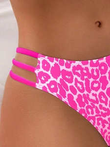 Close-up of pink leopard bikini bottoms featuring triple side straps and high-cut leg