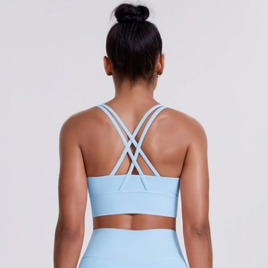 Light blue cross back sports bra and high waist yoga leggings set in a professional studio shot