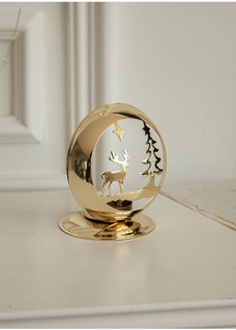 Detailed close-up of golden Christmas reindeer tea light holder with intricate cutouts