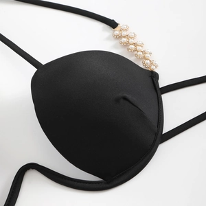 Detail of bikini top with gold chain flower strap, pearls, and rhinestone embellishments