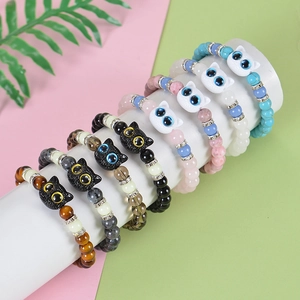 Detailed display of colorful luminous cat bead bracelets with tiger eye stones and metal charms