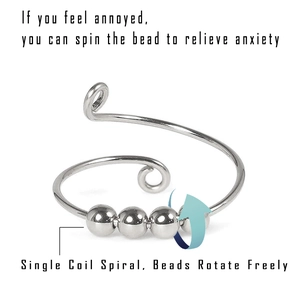 Detail showing rotatable beads on a silver spiral ring designed for anxiety relief