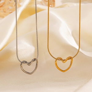 Minimalist 18K gold and silver hollow heart pendants on delicate snake chains for women