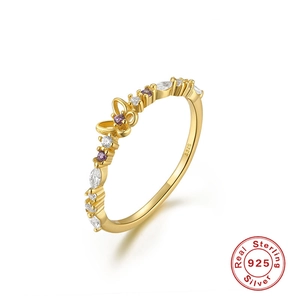 Macro shot of S925 sterling silver gold ring with purple zircon butterfly design
