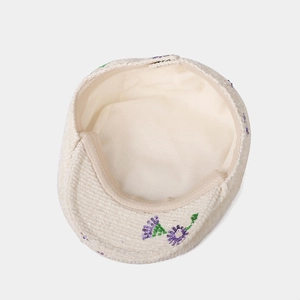 Women's cream corduroy baker boy hat featuring purple sequin floral embroidery detail