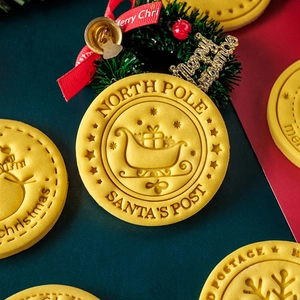 Yellow round Christmas cookie molds with Santa's post and North Pole patterns
