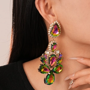 Side view detail of long drop earrings featuring colorful rhinestones on a gold setting