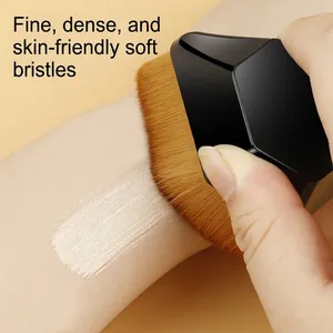Hexagon #55 foundation brush applying liquid makeup smoothly on skin for a flawless finish