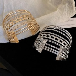 Detailed close-up of multilayer hollow geometric cuff bracelet with matte and glossy textures
