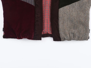 Detailed close-up of velvet, tweed, and patterned lining fabric patchwork on the vest
