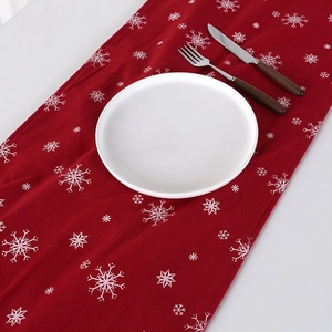 Red Christmas knitted table runner with white snowflake patterns for holiday dining decor