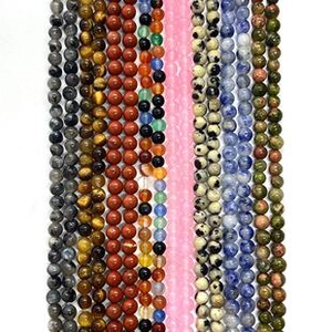 Detailed view of various colorful natural stone round beads for DIY jewelry making