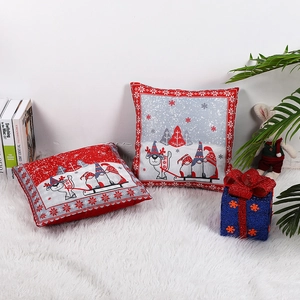 Christmas pillow covers with reindeer and gnome prints on a white plush carpet