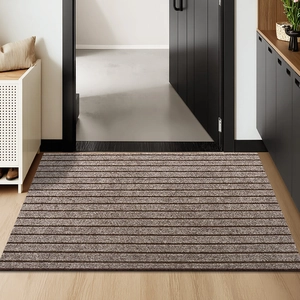 Detailed view of the brown ribbed non-slip entryway mat with striped texture for home