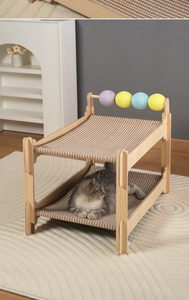 Detail view of double-layer solid wood cat hammock with striped canvas and toy balls