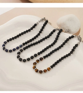 Detail of beaded bracelets set featuring lapis lazuli, tiger eye, and lava stones