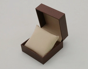 Detail view of brown lychee grain faux leather watch box with beige interior cushion
