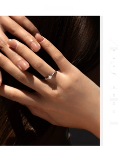 Close-up of elegant square-cut moissanite silver ring worn by a model on dark background