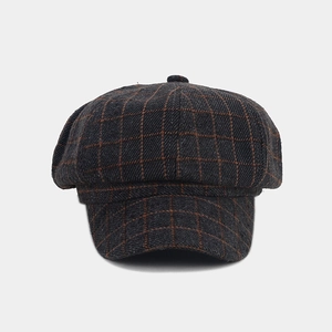 Vintage charcoal and orange plaid newsboy cap with classic eight-panel crown design.