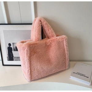 Detail shot of the soft pink plush faux fur texture on this high-capacity tote bag