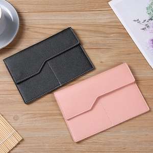 Flat lay of pink and black PU leather envelope pouches with neat white stitching detail