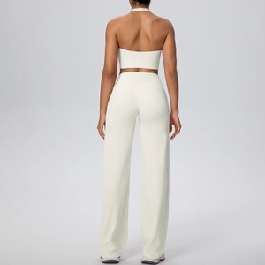 Detail view of the back of a beige halter yoga top and wide-leg trousers sports set