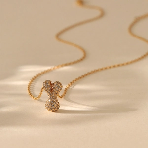 Detail shot of a gold balloon dog pendant pavé-set with sparkling white zircons