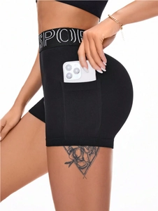 Women's black high-waist seamless sports shorts with side pocket and logo waistband