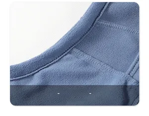 Macro detail of high-quality flatlock stitching on the blue polar fleece interior fabric