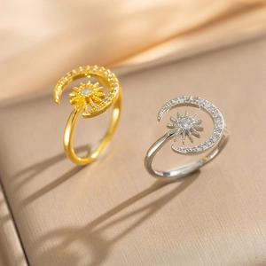 Detailed view of adjustable sun and moon open rings with zircon stones on silk