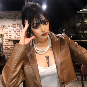 Baroque multi-layer pearl necklace styled with a vintage brown faux leather jacket