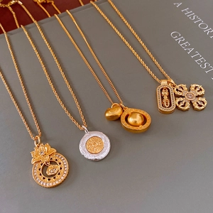 Detailed shot of four gold and silver oriental pendants on twisted rope chains