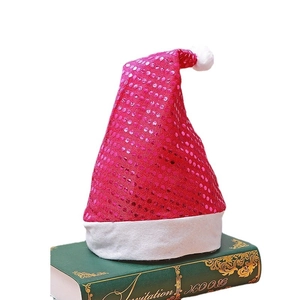 Bonnet de Noël à paillettes rouge rose avec bordure blanche en peluche sur livres