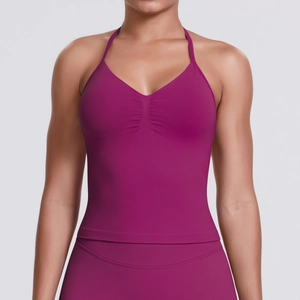 Close-up of deep plum yoga top featuring gathered bust detail and wide ribbed band