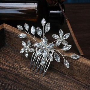 Close-up of handmade bridal hair comb with silver wire, rhinestones, and crystal floral detail
