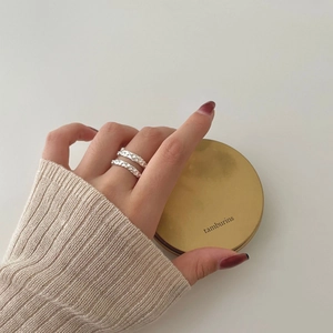 Set of two minimalist 925 sterling silver rings with twisted texture worn on hand