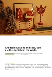 Three red wooden Christmas 'Santa Stop Here' LED signs on a warm festive tabletop