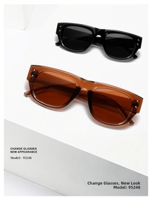 Macro shot of stylish square sunglasses with metallic rivets on white geometric stands