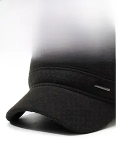 Detail of grey wool textured flat cap with stiff brim and side metal sports logo