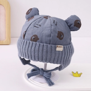 Detail of baby bear ear hat featuring gray corduroy texture and Lucky Bear print