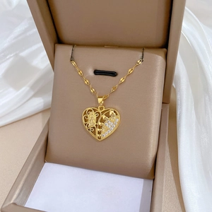 Gold heart necklace with Virgin Mary cutout and crystals displayed in a gift box