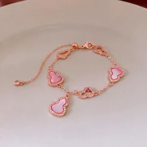 Rose gold bracelet with hollow Wu Lou charms and pink mother-of-pearl zircon inlays