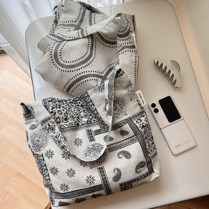 Macro shot of cotton linen tote bags with black and white bohemian paisley and geometric prints