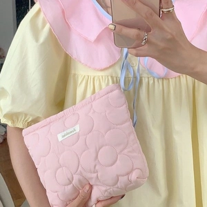 Quilted floral cosmetic bag in pale pink fabric featuring a cute 3D flower pattern