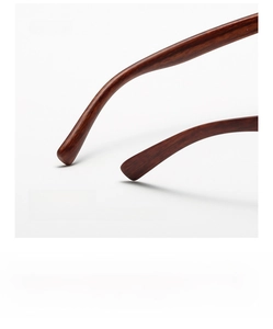 Macro detail of brown wood-grain sunglasses temples with curved non-slip ear rest